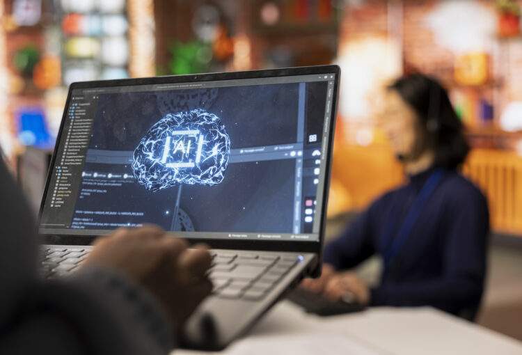 Call center worker using AI tech on laptop to reply to customers, closeup